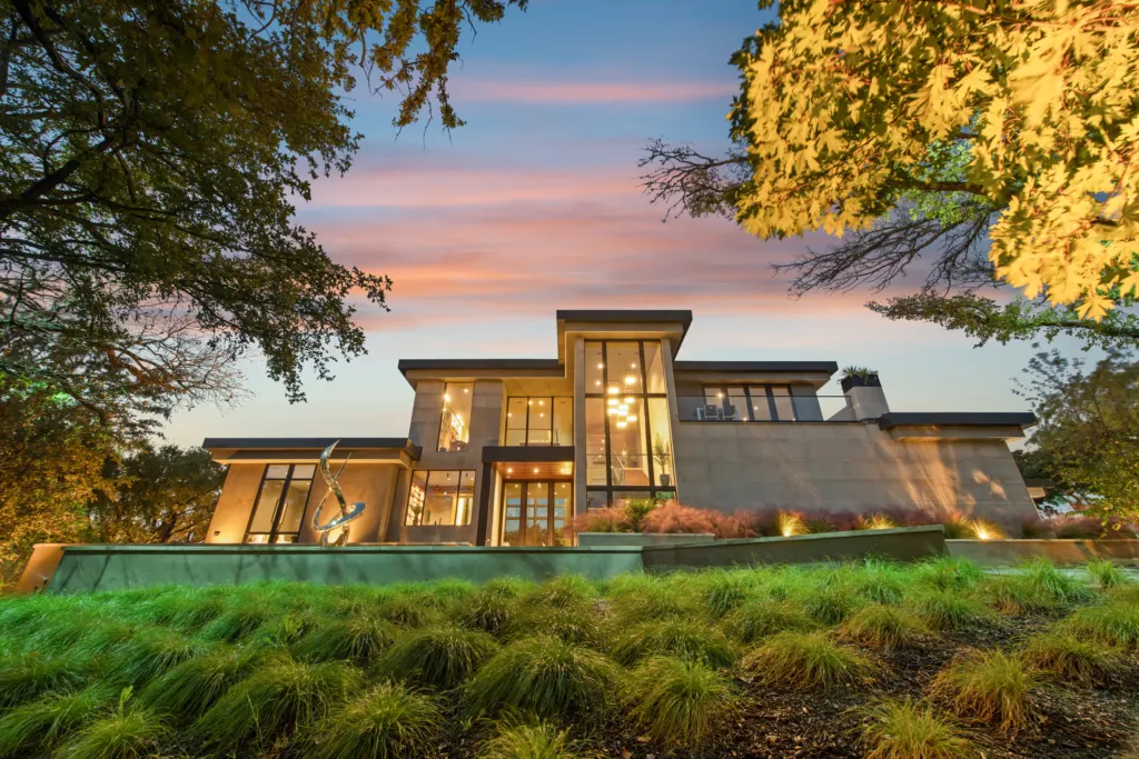 Contemporary villa with landscaped garden at sunset