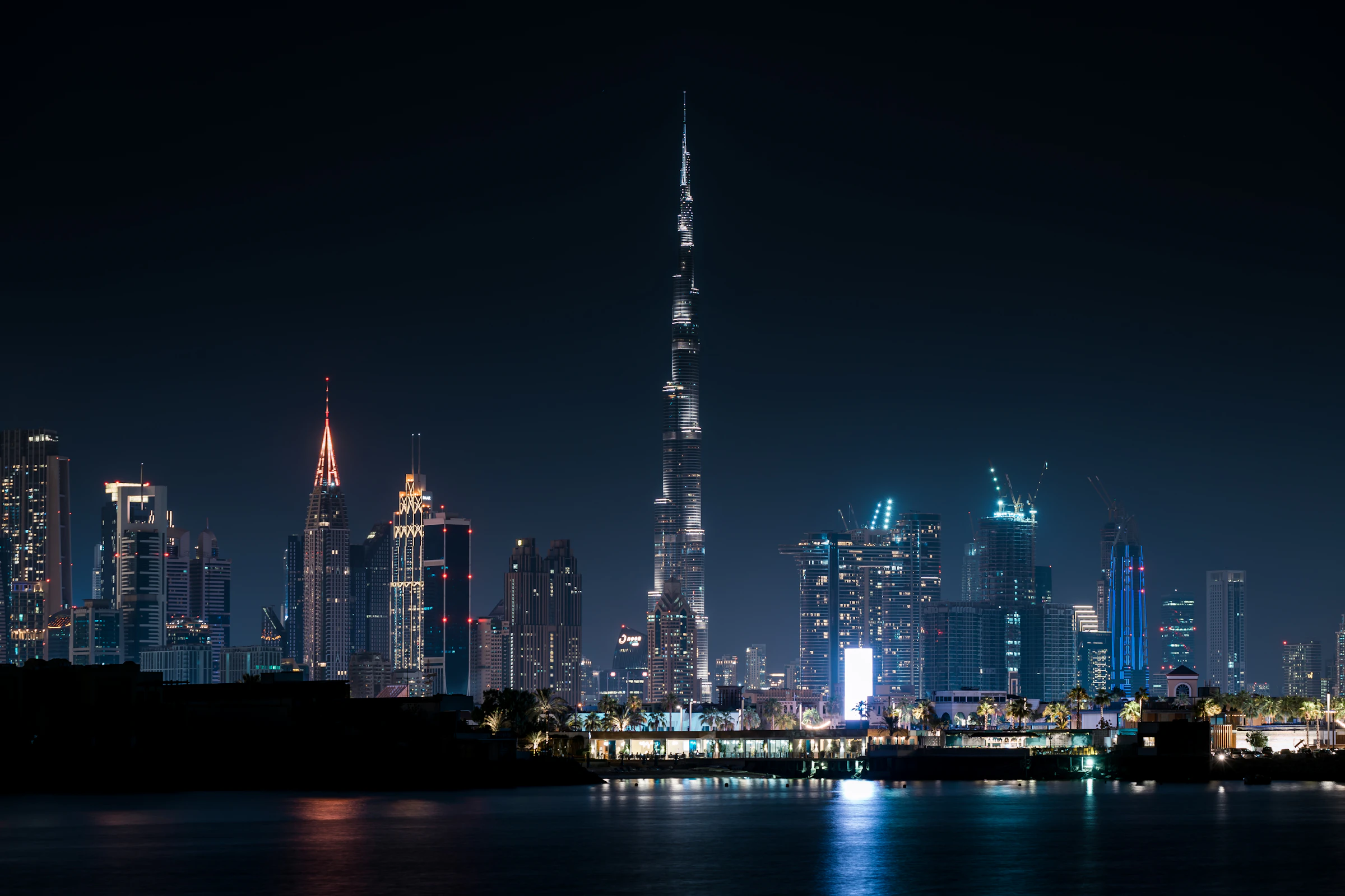 Dubai skyline reflected in the water at night